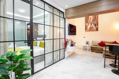 a living room with a large glass wall at Pause in the City - Duplex - Marrakech Centre in Marrakech