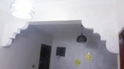 two lights hanging from the ceiling in a room at Beautiful apartment 5' from Macdonald, 10' from Downtown in Marrakech