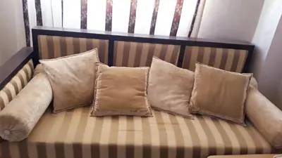 a bunch of pillows sitting on a couch at Beautiful apartment 5' from Macdonald, 10' from Downtown in Marrakech