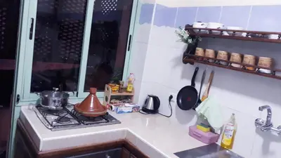 a kitchen counter with a stove and a sink at Beautiful apartment 5' from Macdonald, 10' from Downtown in Marrakech