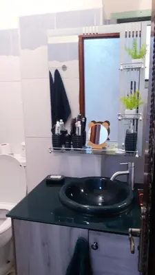 a bathroom with a black sink and a mirror at Beautiful apartment 5' from Macdonald, 10' from Downtown in Marrakech