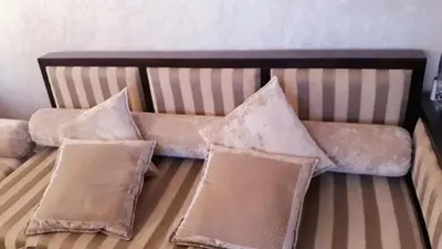 a couch with four pillows on top of it at Beautiful apartment 5' from Macdonald, 10' from Downtown in Marrakech