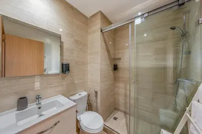 a bathroom with a shower and a toilet and a sink at Prestigia Opale - Superb condo with Golf & Pool views in Marrakech