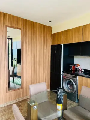 a living room with a table and a kitchen with a washing machine at Bungalow in Marrakech in Marrakech