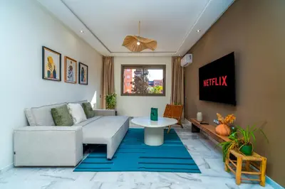 a living room with a couch and a table at Appartement Romantique et Moderne a Gueliz in Marrakech