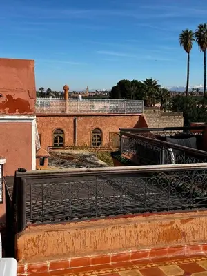 a view of a building with a black fence at Riad Dar Kenza in Marrakech