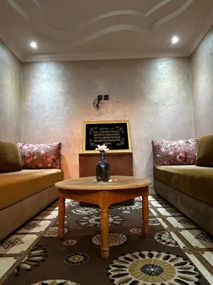 a living room with a couch and a coffee table at Riad Dar Kenza in Marrakech