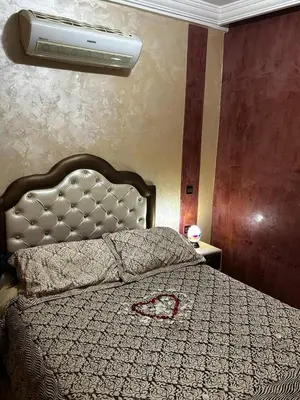 a bedroom with a large bed with a circulator at Riad Dar Kenza in Marrakech
