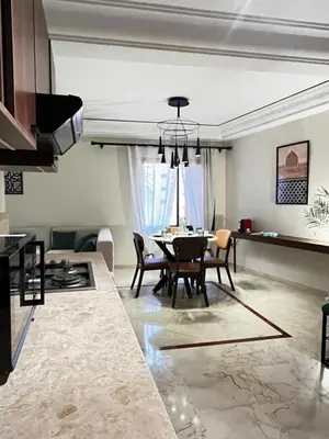 a kitchen and dining room with a table and chairs at Quiet & Central 1BR Apart with Pool in Gueliz in Marrakech