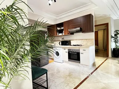 a kitchen with white appliances and a plant at Quiet & Central 1BR Apart with Pool in Gueliz in Marrakech