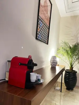 a red suitcase sitting on top of a wooden table at Quiet & Central 1BR Apart with Pool in Gueliz in Marrakech