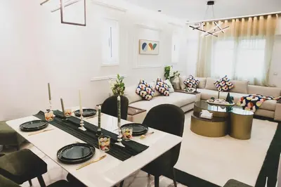 a living room with a table and a couch at Grand appartement Guéliz in Marrakech