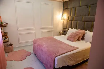a bedroom with a bed with pink pillows on it at Luxurious apartment in Marrakech