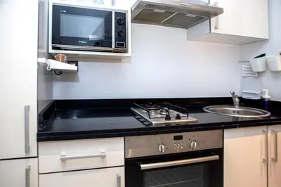 a small kitchen with a sink and a microwave at Luxurious apartment in Marrakech