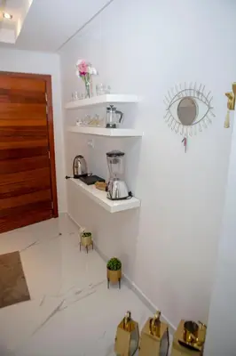 a room with a kitchen with a blender on the wall at Luxurious apartment in Marrakech