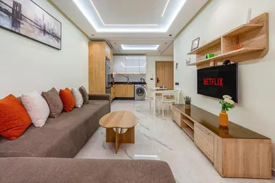 a living room with a couch and a table at Stylish Flat, Aube hivernage Fibre-Pool & Parking in Oulad Akkou