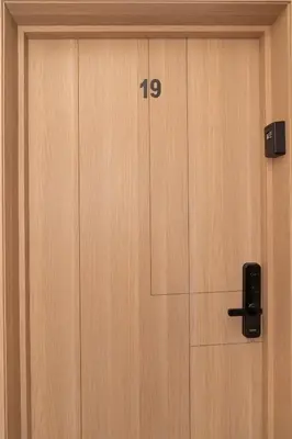a wooden door with the number on it at Stylish Flat, Aube hivernage Fibre-Pool & Parking in Oulad Akkou