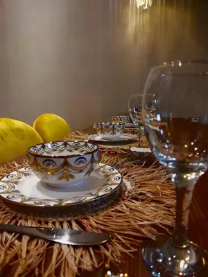 a table with glasses and plates and a wine glass at High Standing Duplex & Pool 10 min Center in Marrakech