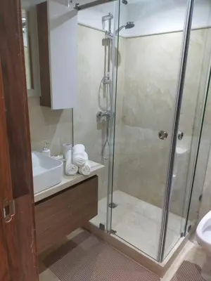 a bathroom with a shower and a sink at High Standing Duplex & Pool 10 min Center in Marrakech