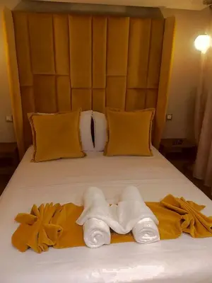 a bed with two towels on top of it at High Standing Duplex & Pool 10 min Center in Marrakech