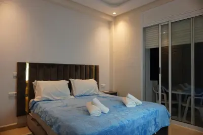 a bedroom with a large bed with white pillows at Comfort Appartment Centre Marrakech in Marrakech