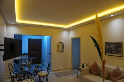 a living room with a table and a couch at Comfort Appartment Centre Marrakech in Marrakech