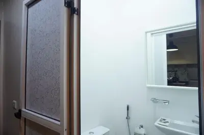 a bathroom with a sink and a toilet and a mirror at Comfort Appartment Centre Marrakech in Marrakech