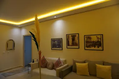 a living room with a couch and pictures on the wall at Comfort Appartment Centre Marrakech in Marrakech