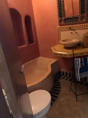 a bathroom with a tub and a toilet and a sink at Riad Zinnha 2 in Marrakech