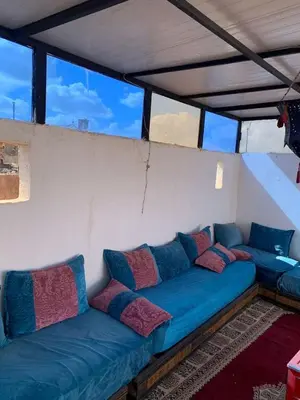 a blue couch with pillows on it in a room at Riad Zinnha 2 in Marrakech