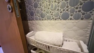 a baby crib with two white towels in it at Marrakech Chic apartment in Marrakech