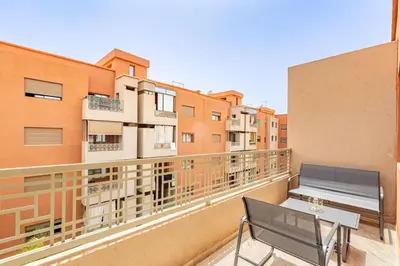 a balcony with a bench and some buildings at Appartement moderne 5 min au centre ville in Marrakech