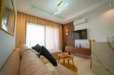 a living room with a couch and a table at Appartement Domaine de Nouria in Marrakech