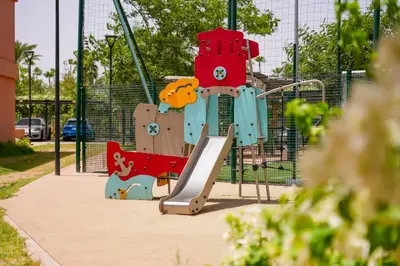 a playground with a slide in a park at Appartement Domaine de Nouria in Marrakech