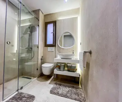 a bathroom with a sink and a toilet and a shower at Appartement avec GOLF PISCINE Prestigia Jade in Marrakech