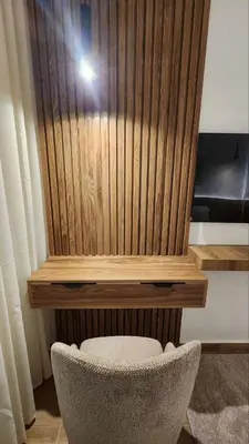 a chair sitting in front of a wooden wall at Appartement avec GOLF PISCINE Prestigia Jade in Marrakech