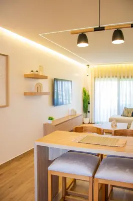a kitchen and living room with a table and chairs at Appartement avec GOLF PISCINE Prestigia Jade in Marrakech