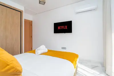 a bedroom with a bed and a sign on the wall at Urban Escape in Gueliz with Balcony and Wifi in Marrakech
