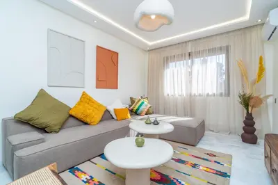 a living room with a couch and two tables at Urban Escape in Gueliz with Balcony and Wifi in Marrakech