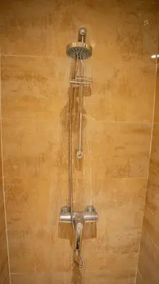a shower with water coming out of it at Yasmine Majorelle Residence Apartment in Marrakech