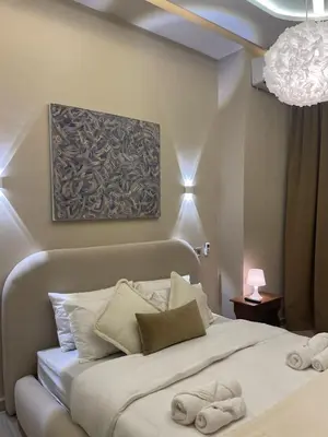 a bedroom with a large white bed with pillows at Majorelle Apartment YSL in Marrakech