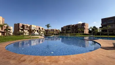 a large swimming pool in the middle of a building at Premium Apartment in Marrakech Argan Golf Residence with pool & WiFi in Marrakech