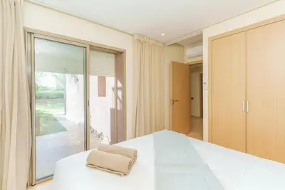 a bedroom with a bed and a large window at Stylish Flat, Pool, Garden & Fast Wi-Fi in Marrakech