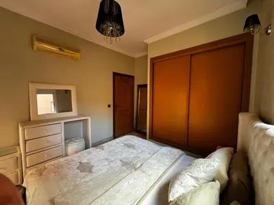 a bedroom with a large bed and a dresser at Luxurious Traditional & Modern Apartment Guéliz in Marrakech