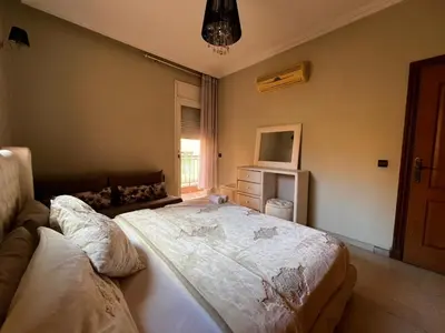 a bedroom with a large bed and a window at Luxurious Traditional & Modern Apartment Guéliz in Marrakech