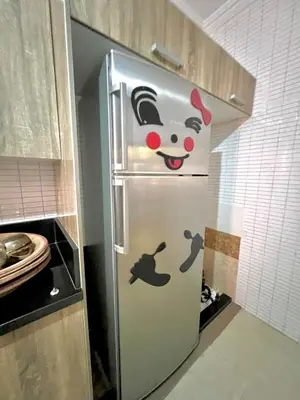 a refrigerator with a hello kitty on it in a kitchen at Lovely Family aparts LAGUASSEM in El Gouassem