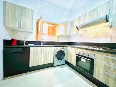 a kitchen with a washer and a dishwasher at Lovely Family aparts LAGUASSEM in El Gouassem
