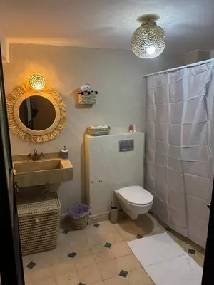 a bathroom with a sink and a toilet and a mirror at Riad Douha in Marrakech
