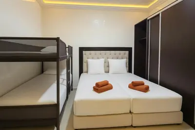 a bedroom with a bed with two brown towels on it at Duplex apart with parking by Sabor Voyage in Marrakech