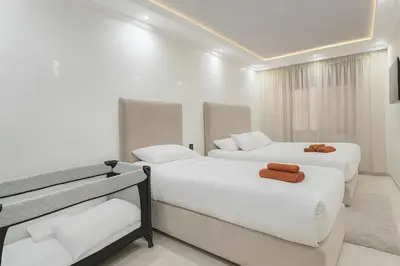 a bedroom with two beds and a television in it at Duplex apart with parking by Sabor Voyage in Marrakech